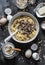 Cooking banana oatmeal cake with white and milk chocolate. Ingredients for the cake on a dark background, top view. Flat lay