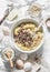 Cooking banana oatmeal cake with white and milk chocolate. Ingredients for the cake on a light background, top view. Flat lay