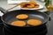 Cooking breaded cutlets in frying pan on stove