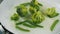 Cooking broccoli and green beans in a frying pan