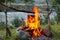 Cooking camp food in cauldron on open fire