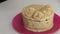 Cooking carrot cake. The woman decorates the cake with cream. Close-up shot