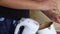 Cooking carrot cake. A woman prepares cake cream, adds boiled condensed milk. Close-up shot