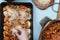 Cooking casserole in a stewpan. Preparation of home-made cake with stuffing. Woman cook puts a stuffing in roasting tin.