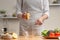 Cooking. Chef crushes lemon juice, in the process of a vegetarian salad in the home kitchen. Light background. Restaurant menu,