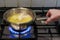 Cooking chicken broth on gas stove