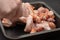 Cooking chicken wings. Man`s hand mixes spices