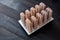 Cooking chocolate ice creame and candies in ice pop molds on a wooden background with copy space