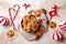 Cooking Christmas gingerbread. Decorated red nosed reindeer cookies with chocolate buttons and melted chocolate.