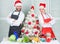 Cooking christmas meal. Man and woman chef apron santa hat near christmas tree. Christmas recipe concept. Secret