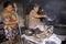 Cooking and cleaning women in kitchen in slum