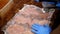 Cooking. close-up. a man chef, wearing protective gloves , beats chicken fillet for chops. prepares food for customers