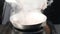 Cooking concept. Chef pouring wine to cook sauce on frying pan. Steam in slow motion. hd