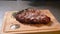 Cooking concept. Grilled marinated beef flank steak on wooden board