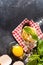 Cooking concept. Ingredients for traditional Italian homemade pasta tomatoes, raw egg, basil leaf on the dark concrete background