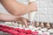 Cooking, confectionery and baking concept. Colorful macarons shells on table with buttercream, and female hands