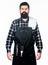 Cooking with confidence. Master cook wearing grilling apron. Confident grill cook. Bearded man with grilling tools