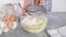 Cooking cottage cheese pancakes, syrniki. Preparation of dough, cooking pastry. Woman adds flour, cooking at home