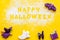 Cooking creepy cookies concept with happy halloween text written on flour on yellow background top view