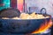 Cooking and deep frying in fatiscent big pan or wok, street food stall in India, junk unhealthy eating. Fire coming out below the