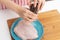 Cooking a delicious diet dinner. Female hands add spices to raw chicken breast