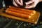 Cooking a delicious lunch with meat sausages on the kitchen table. The chef hands add aromatic spices to the Bavarian sausage