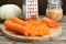 Cooking delicious sauerkraut soup. Fresh chopped carrot on wooden table, closeup