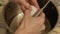 Cooking dough for baking, a woman break an egg into a metal container.