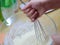 Cooking dough. Stir the dough with a whisk. Stirring whisk dough