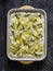 Cooking focaccia with potatoes and rosemary on a dark background, top view. Raw food