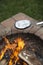 Cooking a foil covered pan of popcorn on fire pit