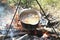 Cooking food in a kettle on a firewood fire