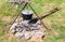 Cooking food over an open fire at the campsite in summer