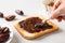 Cooking fresh crispy toast with dates jam on white table.