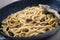 Cooking Fresh Tagliatelle with mushrooms in a Pan