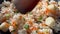 Cooking fried rice with fish cakes on a frying pan. POV close-up view of preparing white rice with carrot and shallot