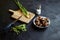 Cooking garden snails. Wooden cutting board and ingredients. Fresh mint leaves, green scallion, knife, pepper, salt cellar and