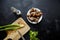 Cooking garden snails. Wooden cutting board and ingredients. Fresh mint leaves, green scallion, knife, pepper, salt cellar and