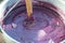 Cooking grape juice, corn and white flour in big pot boiler mixing with wooden spoon for pelamushi, tatara or churchkhela -