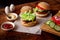 Cooking a hamburger. Stacking vegetables in a hamberger. The ingredients are different on a wooden background. Hamburger day