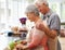 Cooking, health and love with old couple in kitchen for salad, help and nutrition. Happy, smile and retirement with