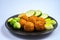 Cooking of healthy vegetarian food, tasty check pea falafels and frehs green vegetables