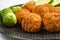 Cooking of healthy vegetarian food, tasty check pea falafels and frehs green vegetables