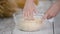 Cooking and home concept, close up of female hands kneading dough at home.