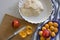 Cooking homemade apricot pie. Slices of fresh apricots for pie on a cutting board, dough in a white baking dish.