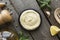 Cooking homemade mayonnaise, garlic cream sauce. Seasonings on wooden background