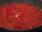 Cooking homemade tomato sauce using fresh summer tomatoes, onion and garlic . Italian recipe