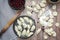 Cooking homemade Ukrainian dumplings with cherries on a wooden table