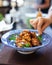 Cooking karaage chicken, japanese fried chicken in a traditional blue bowl, upright