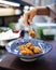 Cooking karaage chicken, japanese fried chicken in a traditional blue bowl, upright